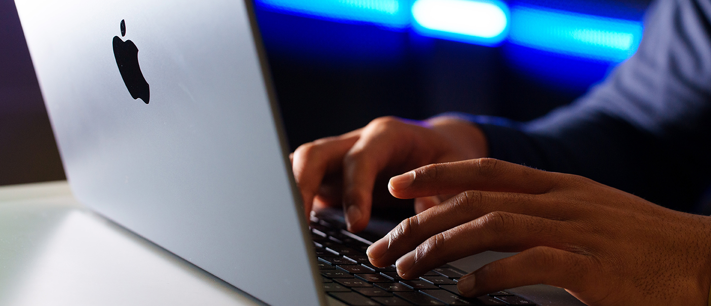 Hands working on a laptop