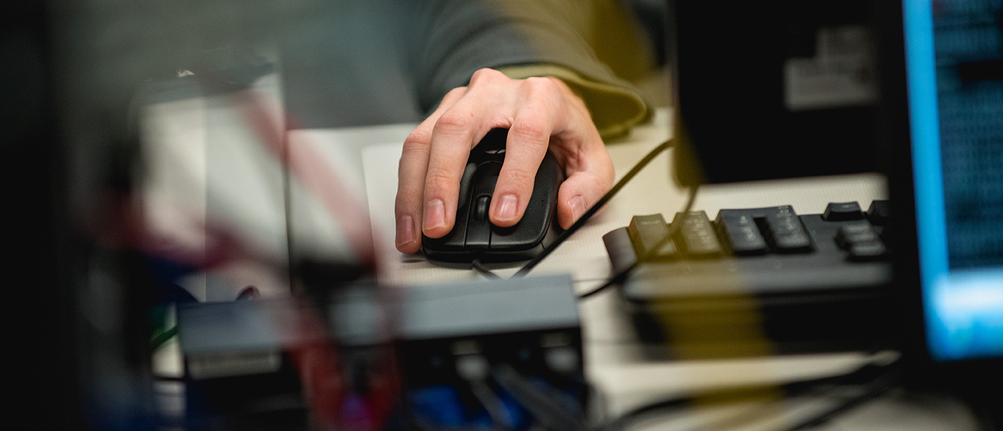 A hand using a computer mouse