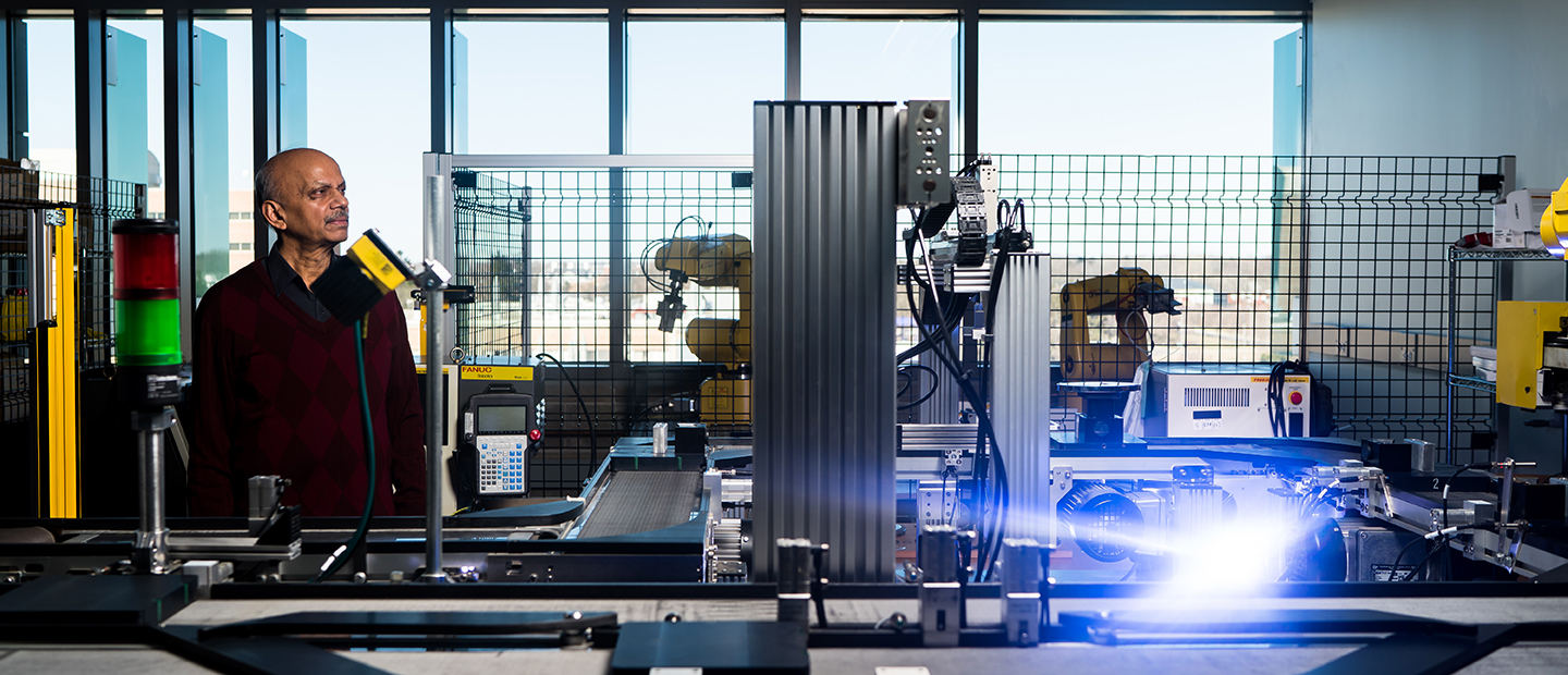 A man in an industrial/mechanical lab