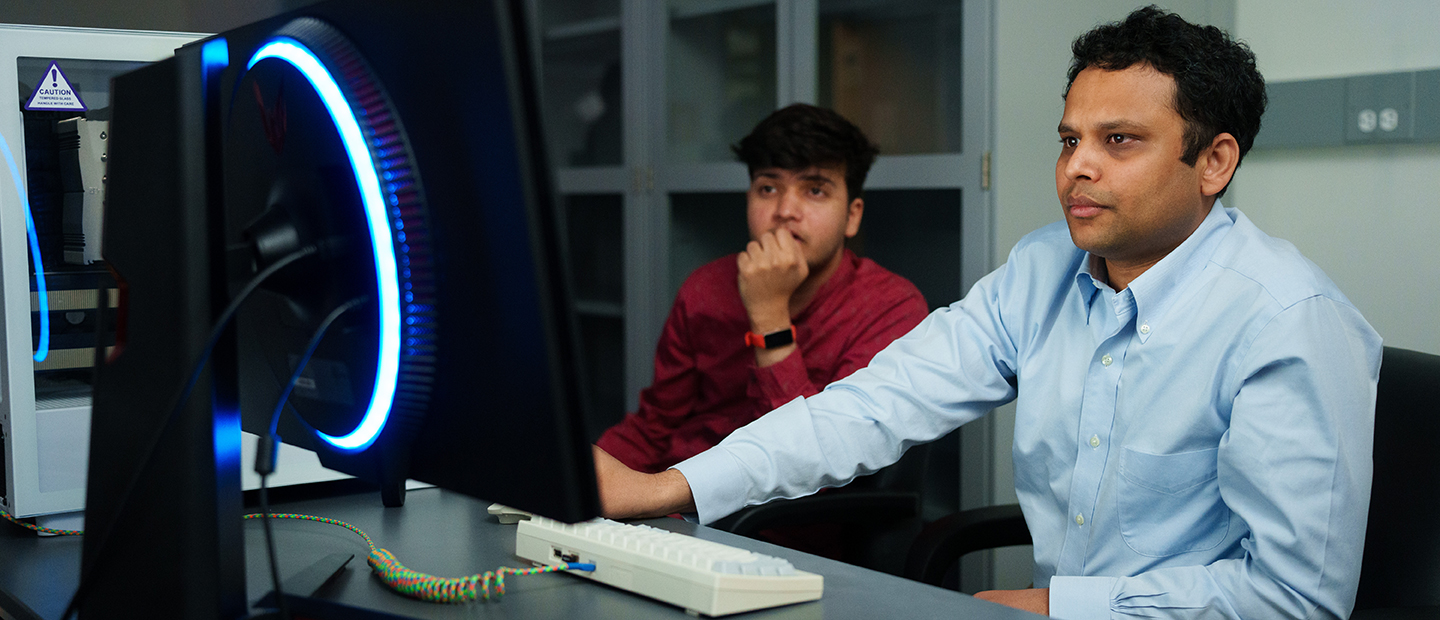 Two men working at a computer