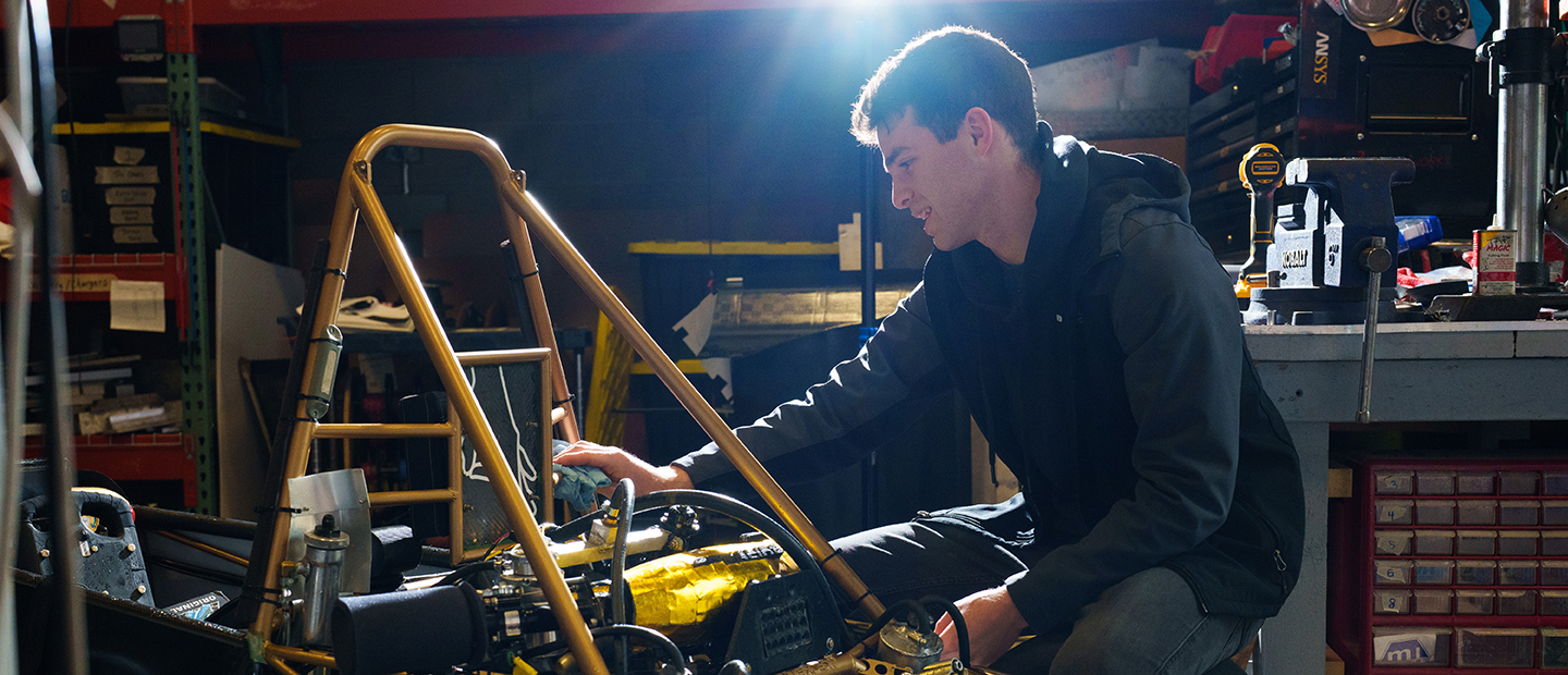 A young man working on mechanical equipment