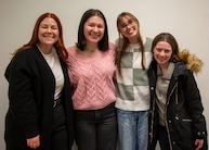 Professor Katie Sloan posing with a group of students