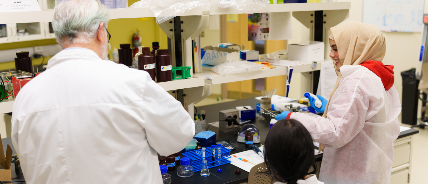 Three people working together in a lab.