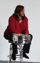 Gayelynn McKinney seated at a drum