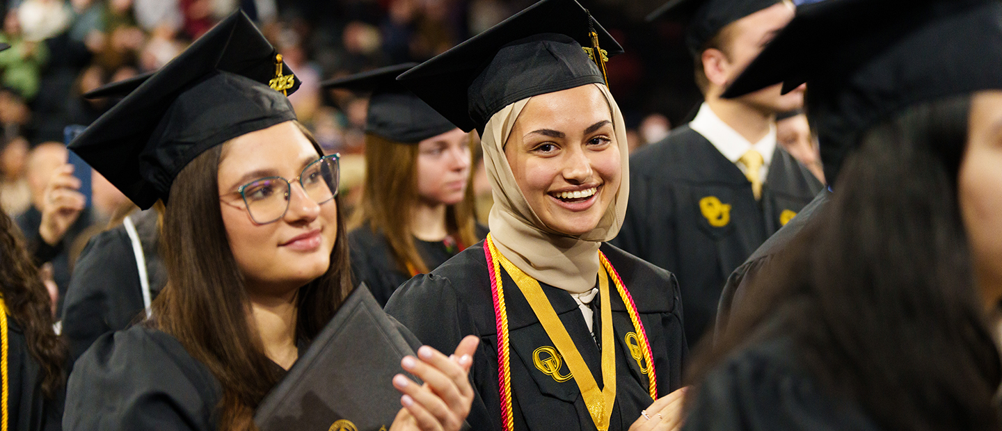 Two Oakland University graduates at Commencement