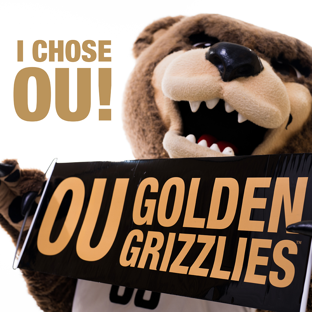 Grizz holding a banner that says 