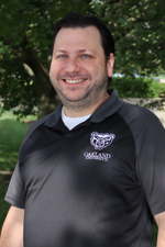 A headshot of Chris Stepanian Bennett outdoors