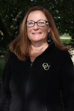 A headshot of Kathy Meerhaeghe outdoors.