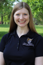 A professional headshot of Ruthie Paula in a black Oakland University shirt.