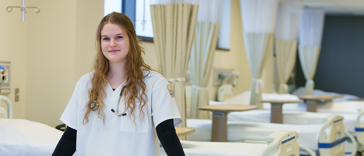 student near lab bed