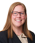 Headshot Blonde Woman in tan top and black jacket wearing glasses smiling at the camera Academic Advisor