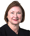 Headshot Woman in Black top with short brown hair. Academic Advisor