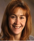 Headshot: Closeup of woman smiling at the camera.